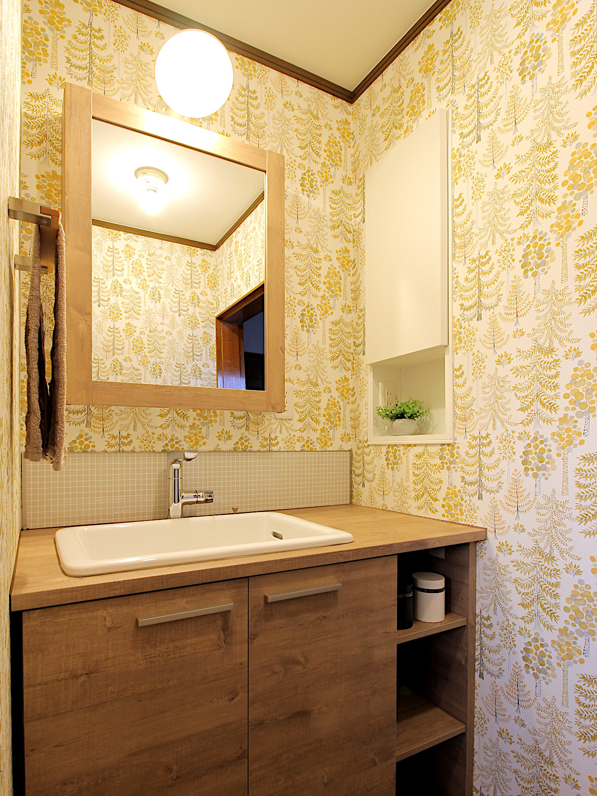 サンゲツ77-3097の壁紙とTOTOドレーナラフスモークウッドを採用した洗面リフォーム。