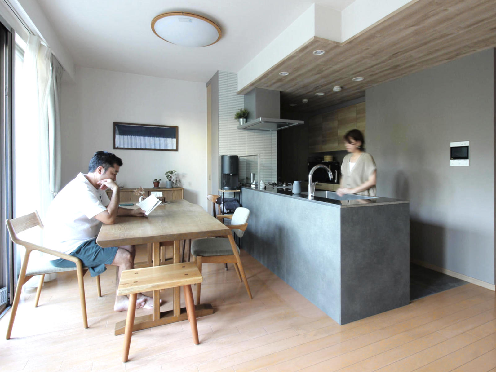 名古屋市西区のリノベーション事例。グレーのキッチンと木目天井FE76580を組み合わせ、広がりあるダイニング空間を実現。